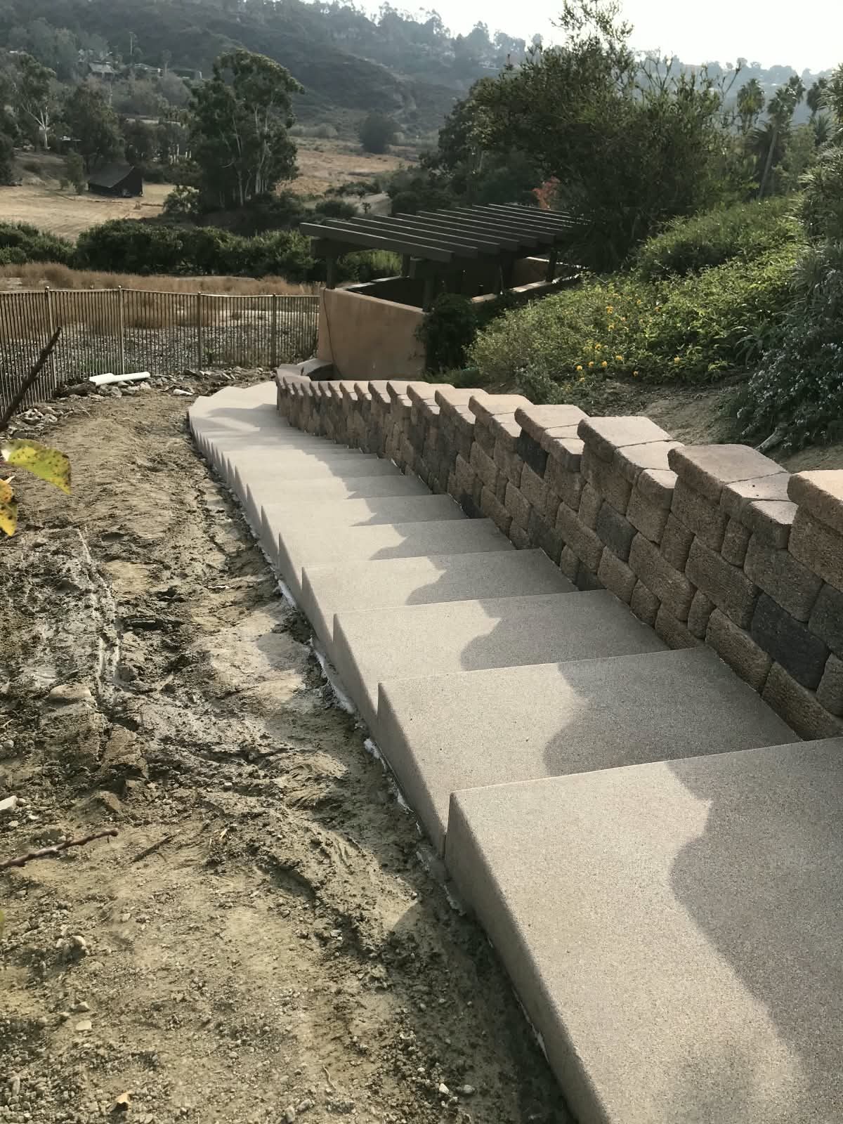 Concrete steps next to a block wall